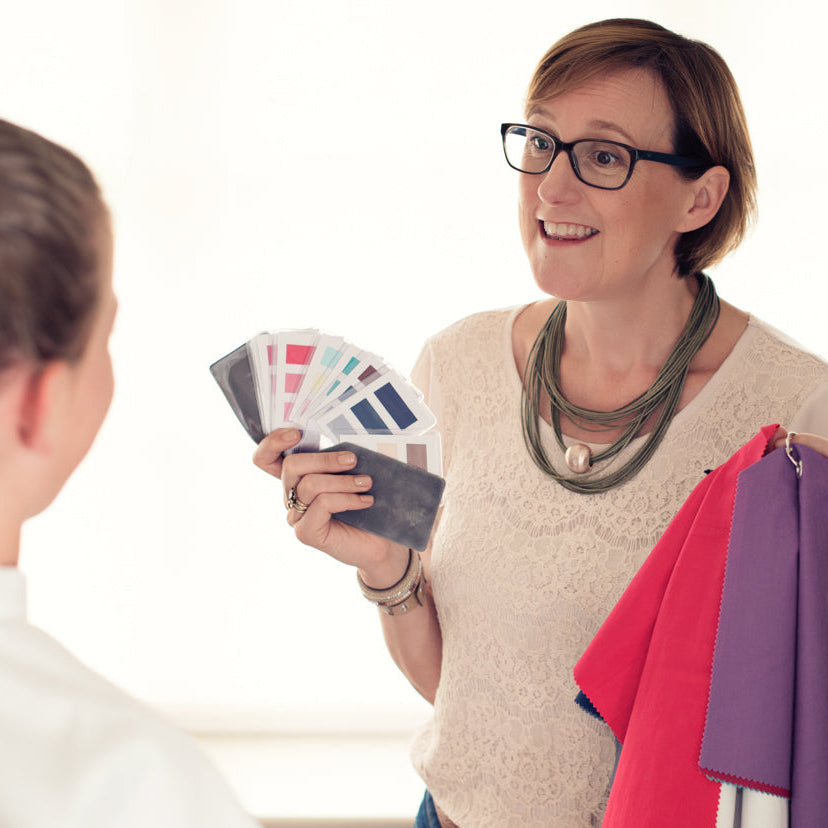 Victoria exploring fabric colour swatches with a client
