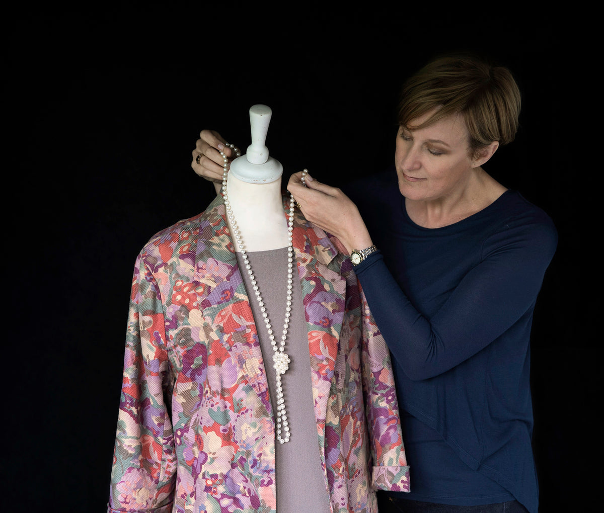 Victoria placing a necklace on a mannequin at Frankie & Ruby